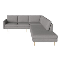 Stylish gray sectional sofa with a minimalist design and wooden legs, featuring clean lines and a modern aesthetic.