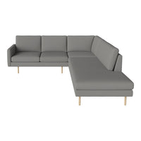 Gray sectional sofa with clean lines and minimalist design, featuring light wooden legs. Perfect for modern decor.