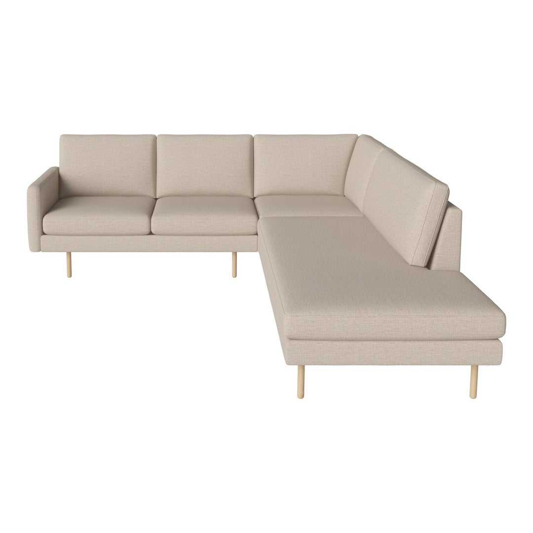 Beige sectional sofa with clean lines and a smooth fabric finish, featuring minimalist design and light wooden legs.