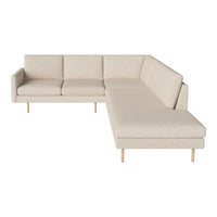 Light beige sectional sofa with a minimalist design and subtle textured fabric, featuring natural wood legs.
