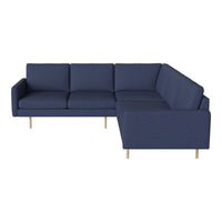Navy blue sectional sofa with a minimalist design and textured fabric, featuring light wooden legs.