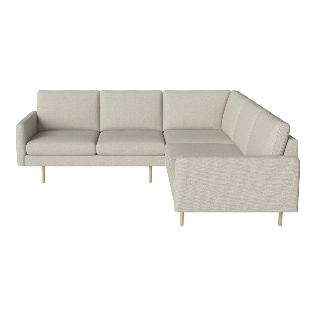 Light beige sectional sofa with a simple, modern design and soft fabric upholstery. Minimalist wooden legs.