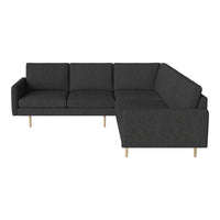 Dark gray sectional sofa with sleek lines and a textured fabric finish, complemented by light wooden legs.