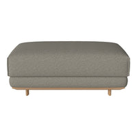 Gray upholstered ottoman with a smooth finish and light wooden legs, featuring a subtle textured pattern.