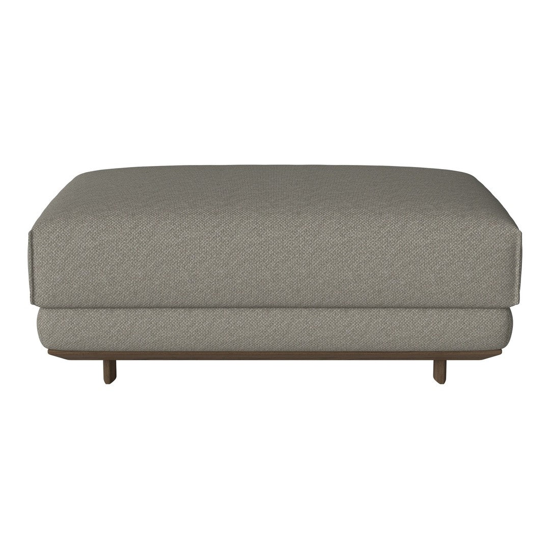 Gray upholstered ottoman with a subtle textured pattern and a stylish wooden base. Ideal for modern interiors.