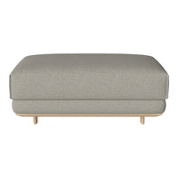 Gray upholstered ottoman with a smooth texture and minimalist design, featuring natural wood legs for a contemporary look.
