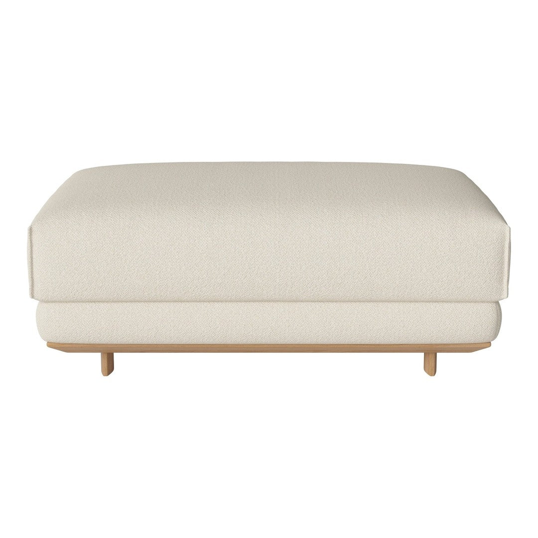 Cream-colored ottoman with a smooth texture and minimalist design, featuring natural wood legs.