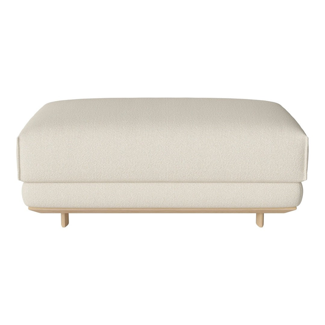 Cream-colored upholstered ottoman with a smooth texture and minimalist design, featuring light wooden legs.