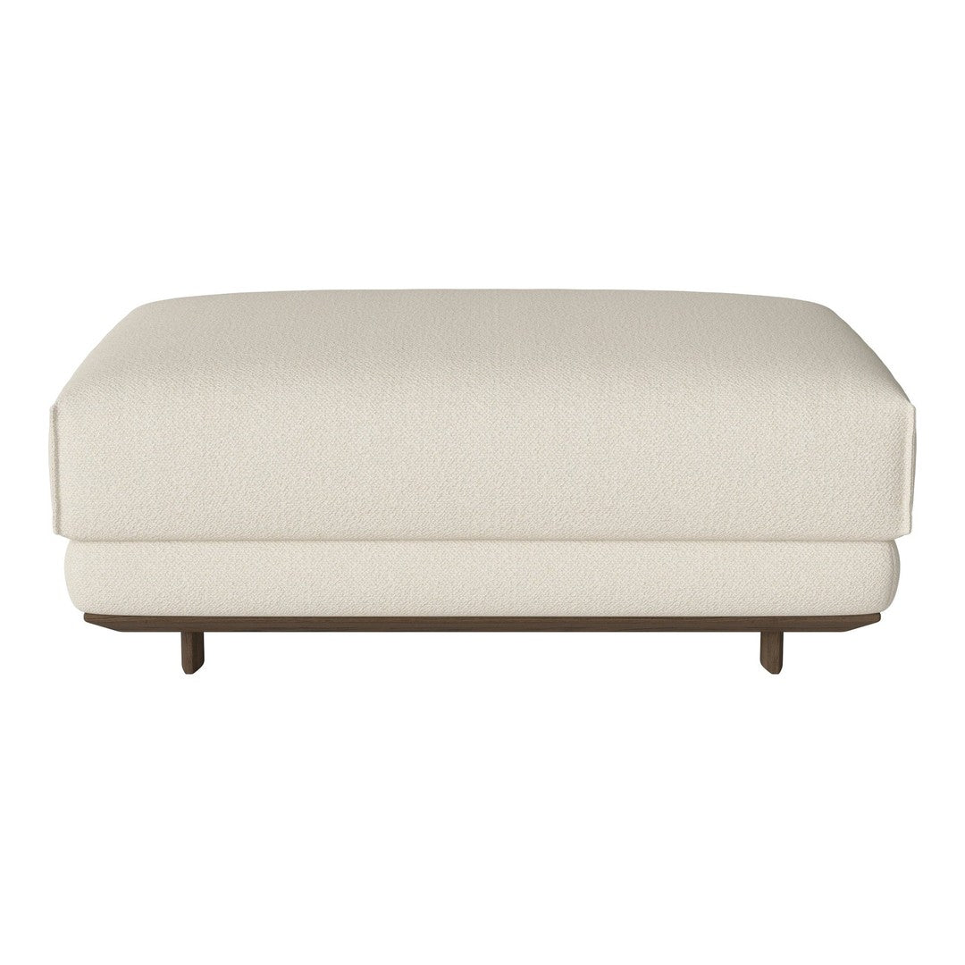 "Textured cream ottoman with a sleek design and wooden base, perfect for modern decor."