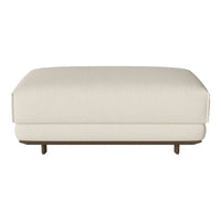 "Textured cream ottoman with a sleek design and wooden base, perfect for modern decor."