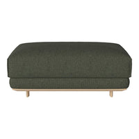 Dark green upholstered ottoman with subtle textured pattern, featuring a light wood base.