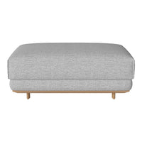 Gray upholstered ottoman with a smooth, textured pattern and light wooden legs. Simple and modern design.