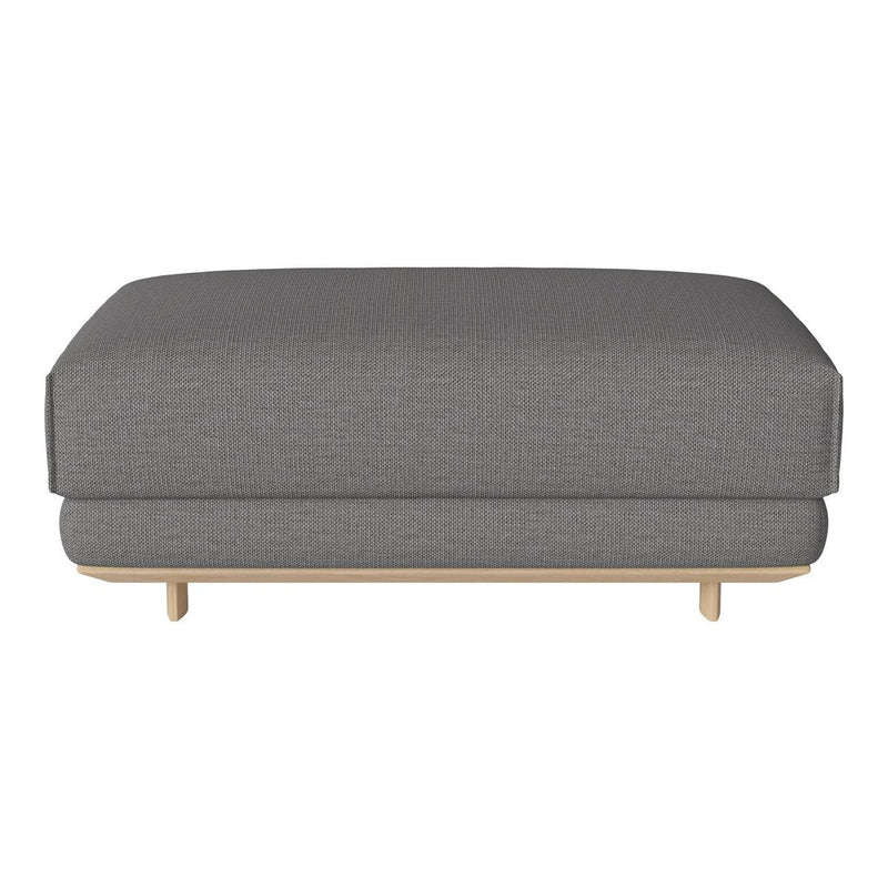 Gray upholstered ottoman with a subtle textured pattern and light wood legs. Perfect for modern living spaces.