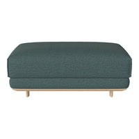 Teal upholstered ottoman with a subtle textured pattern and natural wood legs. Ideal for modern decor.