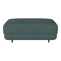 Teal upholstered ottoman with textured fabric and minimalist design, featuring wooden legs for modern appeal.