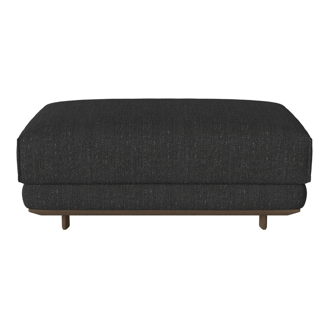 Dark gray upholstered ottoman featuring a subtle textured pattern and wooden legs. Stylish and modern design.