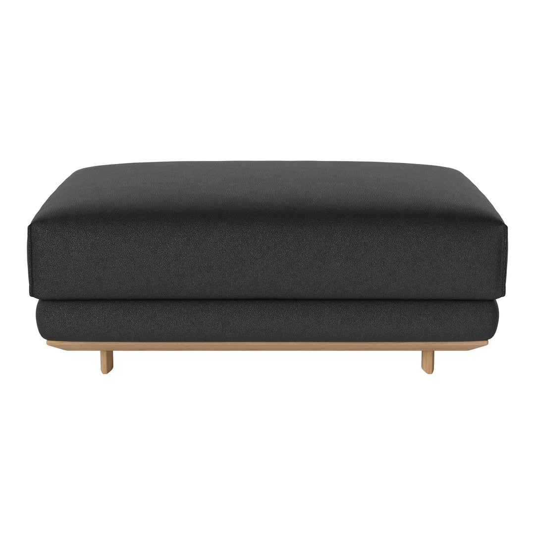 Black upholstered ottoman with a smooth surface and light wood legs, minimalistic design and modern style.