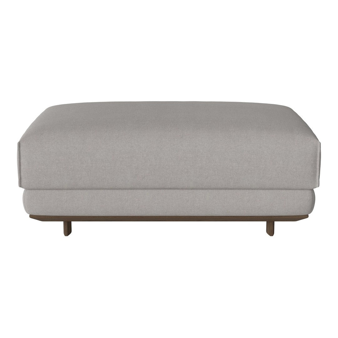 Light gray upholstered ottoman with a smooth, minimalist design and wooden base.