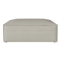 Square ottoman in light beige fabric with a subtle ribbed texture and smooth, rounded corners. Ideal for modern decor.