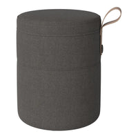 Gray cylindrical storage ottoman with a textured fabric and a tan leather handle.