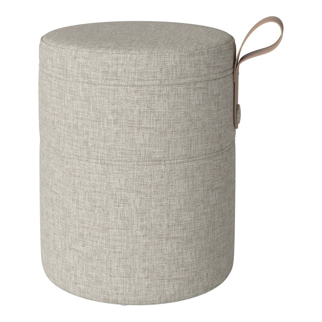Light gray cylindrical storage ottoman with a textured fabric pattern and a brown leather handle.