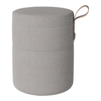 Grey fabric storage ottoman with a round shape and a top handle for easy mobility. Simple, modern design.