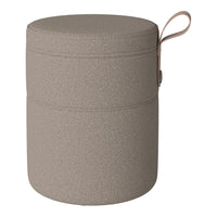 Round, textured storage container in muted beige with a simple, minimalist design and a convenient handle.
