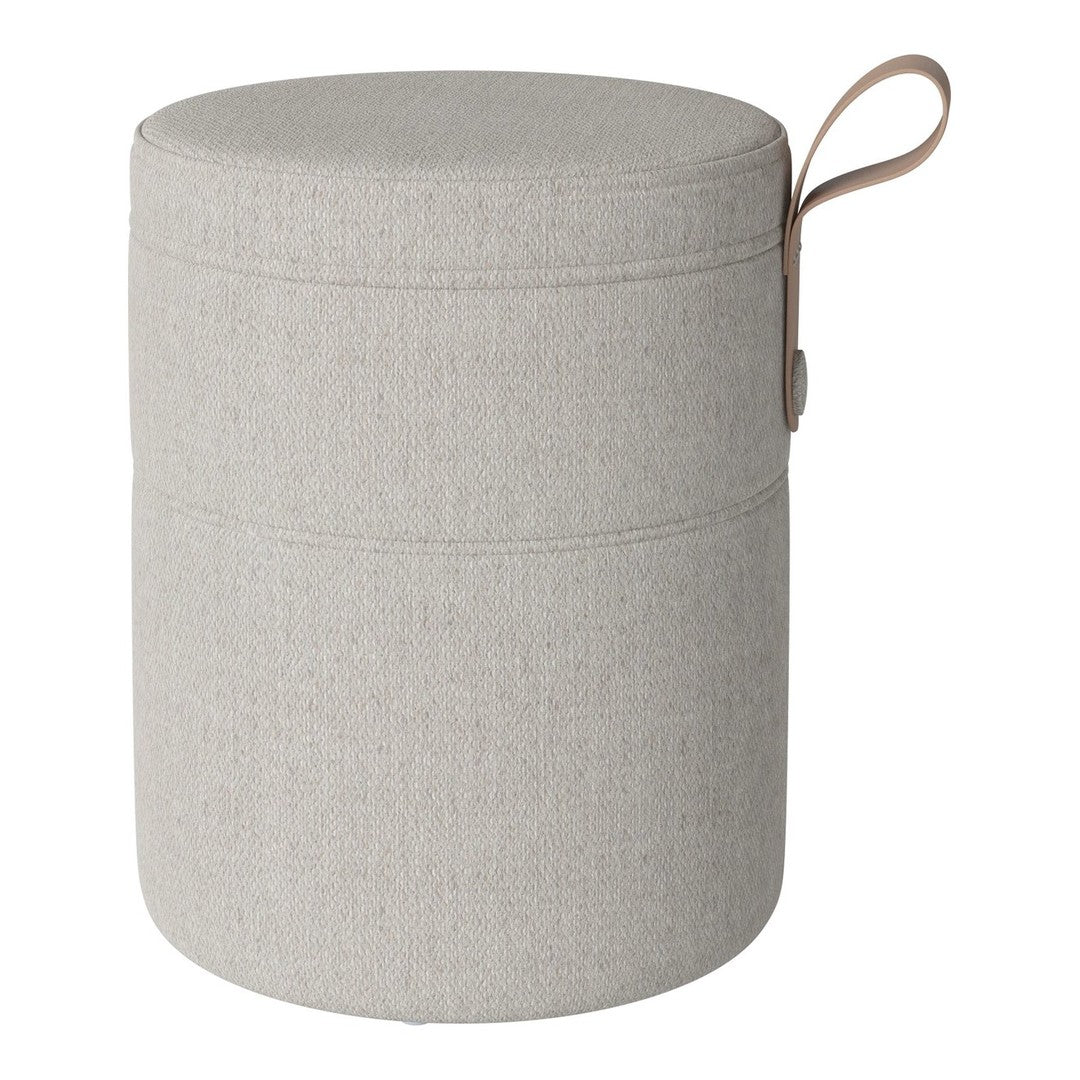 Round gray storage ottoman with a textured fabric pattern and a brown leather handle. Ideal for modern decor.