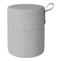 Gray cylindrical storage ottoman with a textured fabric pattern and a tan handle for easy carrying.