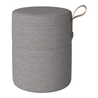 Gray fabric storage ottoman with a smooth texture and subtle horizontal patterns, featuring a brown handle.