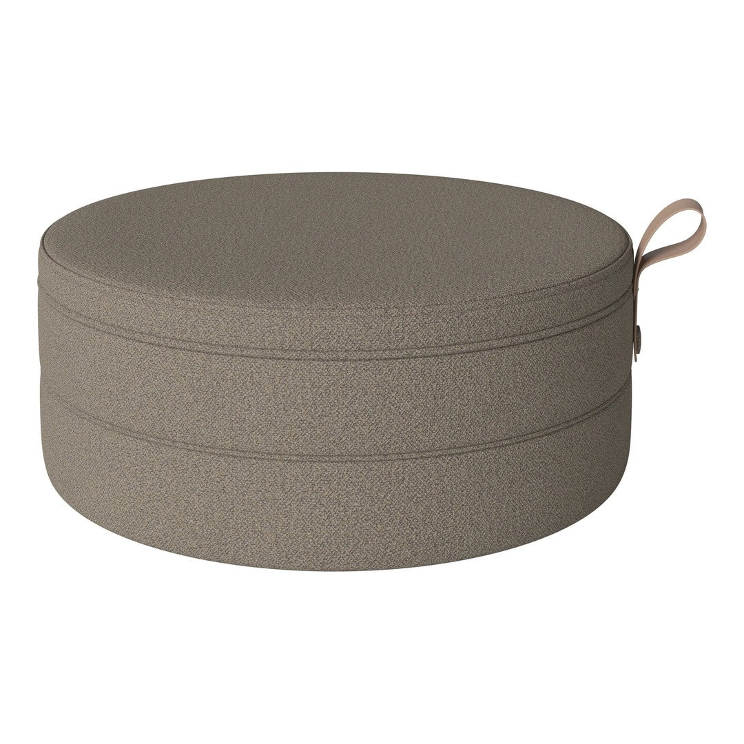 Round pet bed in a textured, muted taupe color with a simple woven pattern. Ideal for modern home decor.