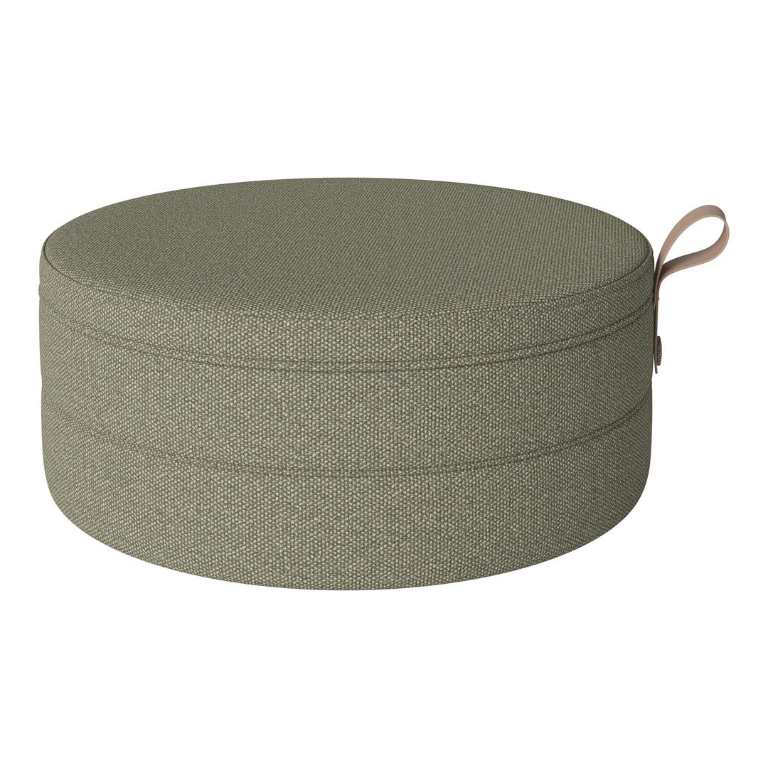 Round olive green pouf with a textured finish and a decorative handle. Perfect for modern decor.
