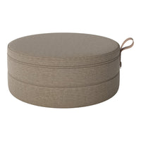 Round storage ottoman in warm beige with subtle textured stripes and a practical carrying handle.