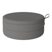 Round gray storage pouf with a textured pattern and a convenient beige handle. Perfect for modern decor.