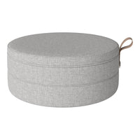 Gray round pouf with a textured fabric and a stylish handle, perfect for modern home decor.