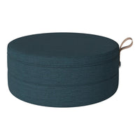 Round teal storage ottoman with a smooth, textured surface and a stylish tan handle.