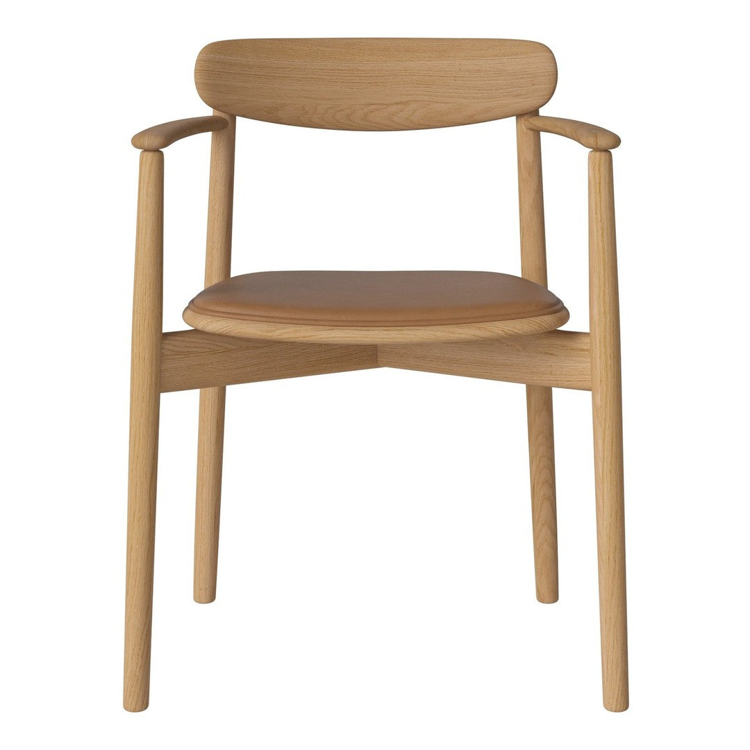 Light wood chair with a sleek, minimalist design and a tan leather seat, showcasing natural textures and warm tones.
