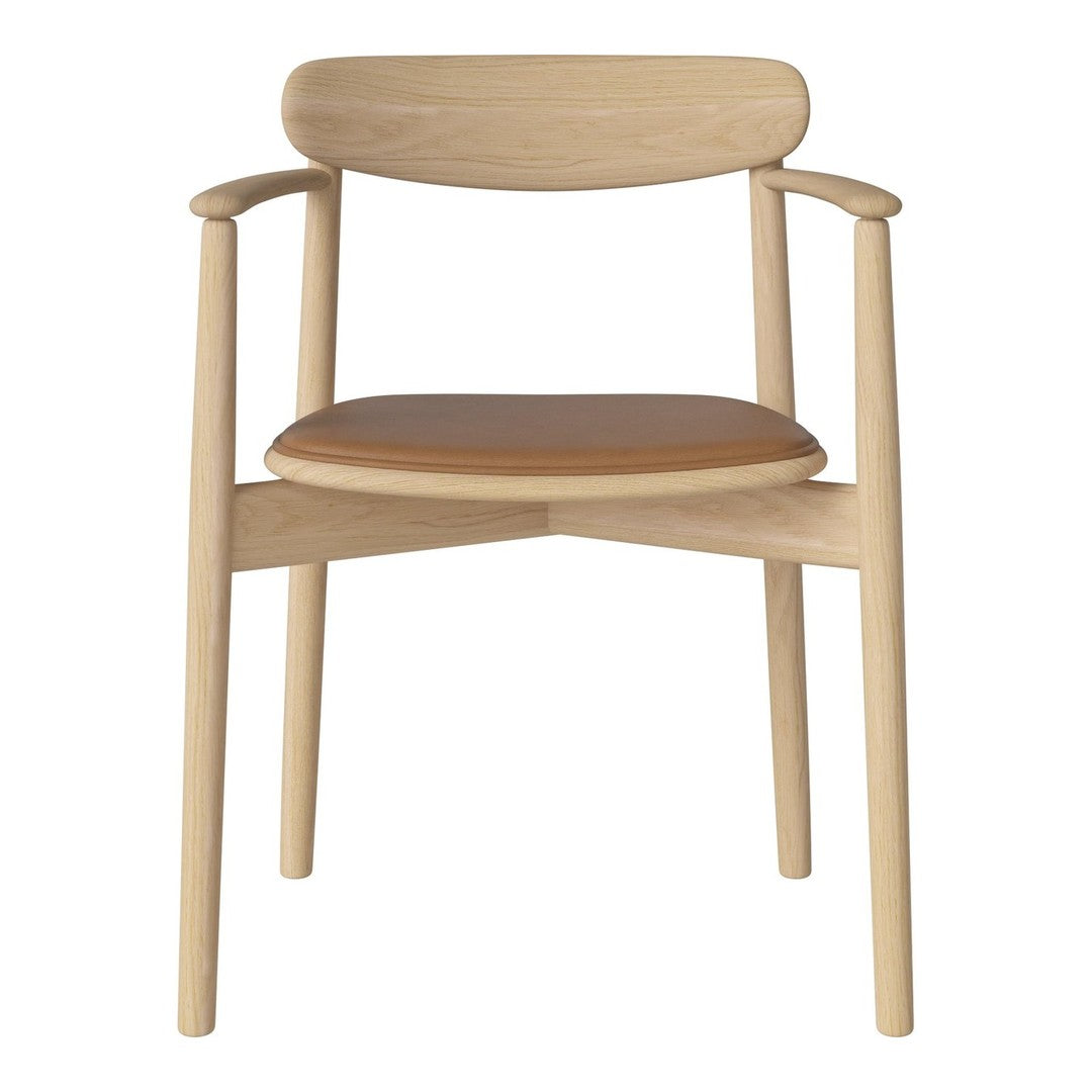 Light oak armchair with a sleek design and a warm tan seat, featuring minimalistic lines and natural wood grain.