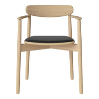 Light wood chair with a smooth finish and a sleek black seat cushion. Simple, modern design with no patterns.
