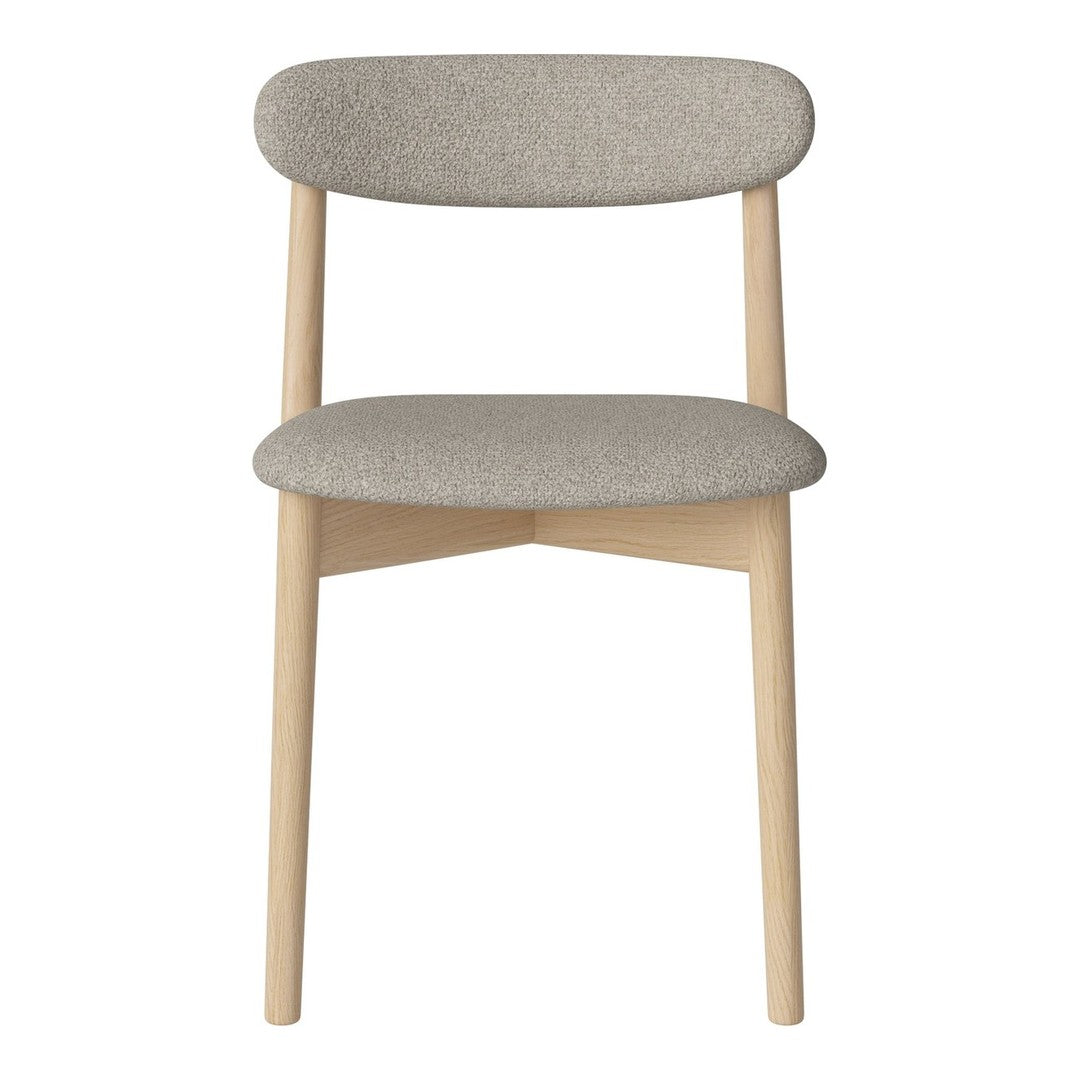 Light gray upholstered chair with a smooth, minimalist design and natural wood legs. Modern and stylish accent piece.