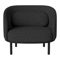 Modern black armchair with a textured fabric and smooth, rounded silhouette on a minimalist metal frame.