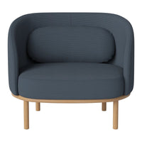 Dark blue ribbed fabric armchair with a smooth, rounded design and light wood legs, perfect for modern decor.