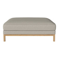 Light gray upholstered ottoman with a smooth texture and natural wood legs, enhancing modern decor.