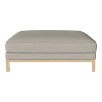 Light beige ottoman with a smooth fabric texture and clean wooden legs, perfect for modern minimalist decor.