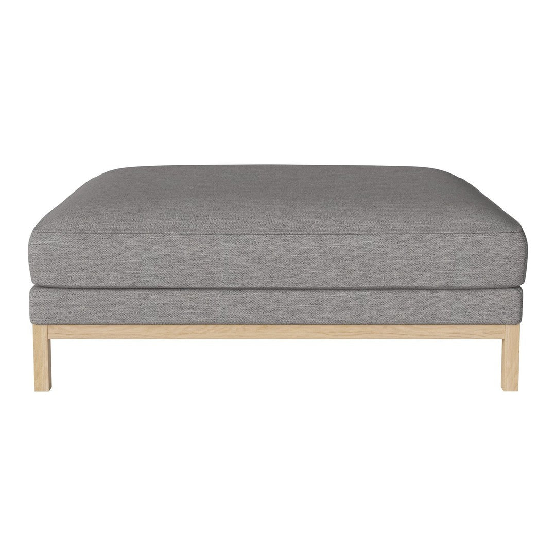 Gray upholstered ottoman with a plush cushion and light wooden legs, featuring a minimalist design.