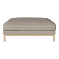 Light gray upholstered ottoman with a minimalist design and natural wood base. No patterns, smooth texture.