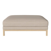 Beige upholstered ottoman with subtle textured pattern and light wood base. Versatile and stylish for any living space.