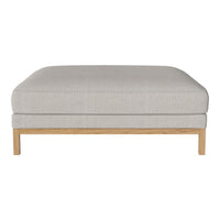 Light gray upholstered ottoman with a smooth finish and natural wood legs. Minimalist design for a modern look.