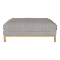 Light gray upholstered ottoman with a smooth texture and natural wood legs, perfect for modern decor.