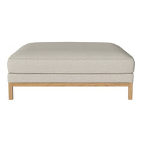 Light beige upholstered ottoman with a textured finish and a natural wood base. Modern and minimalist design.